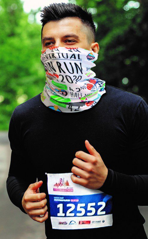 man running face covered by bandanna walks marathons and charities